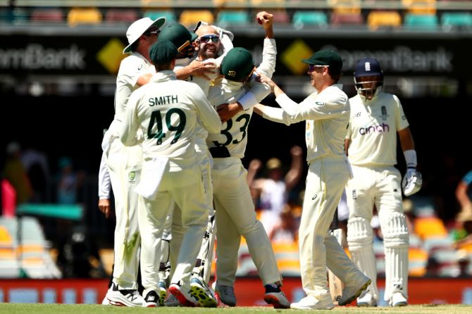 Australia's Nathan Lyon celebrates dismissing England's Dawid Malan and taking his 400th Test wicket during Day 4 of the first Ashes Test, at The Gabba in Brisbane, on Saturday. 