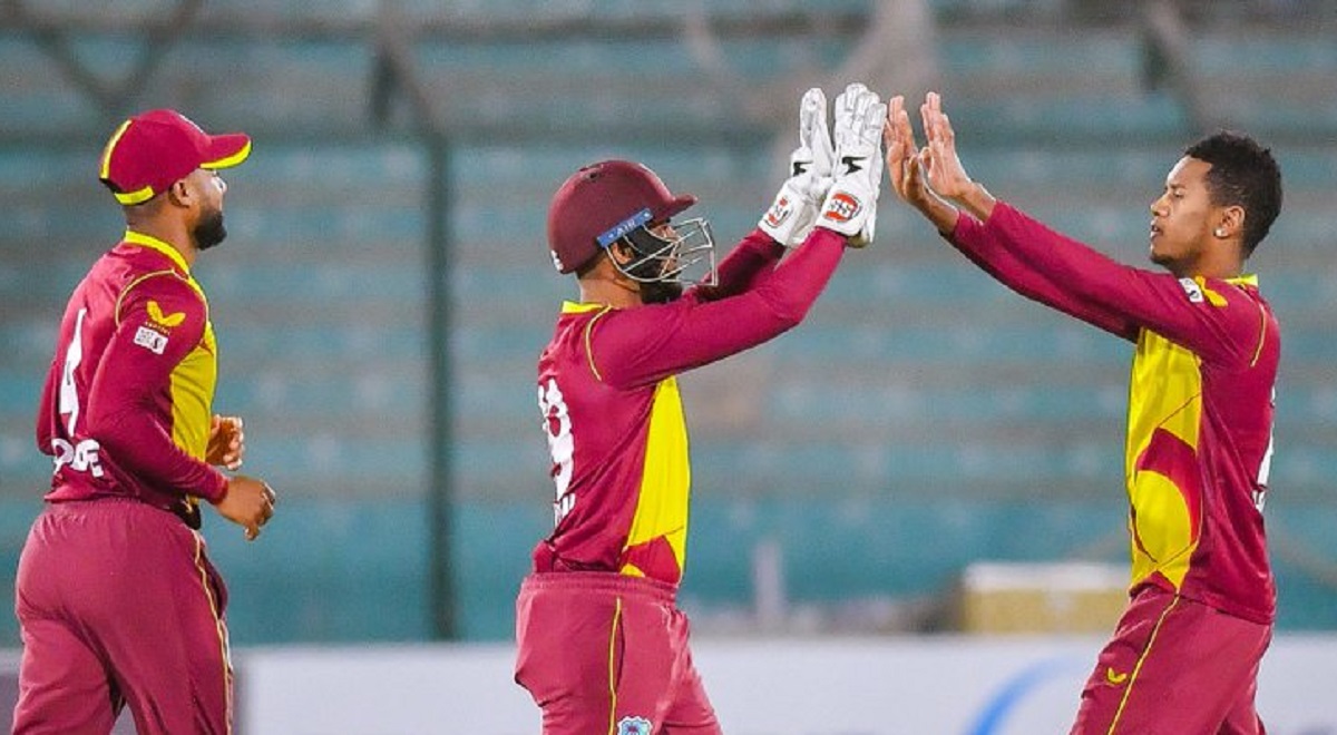 West Indies' Akeal Hosein celebrates a wicket with teammates.