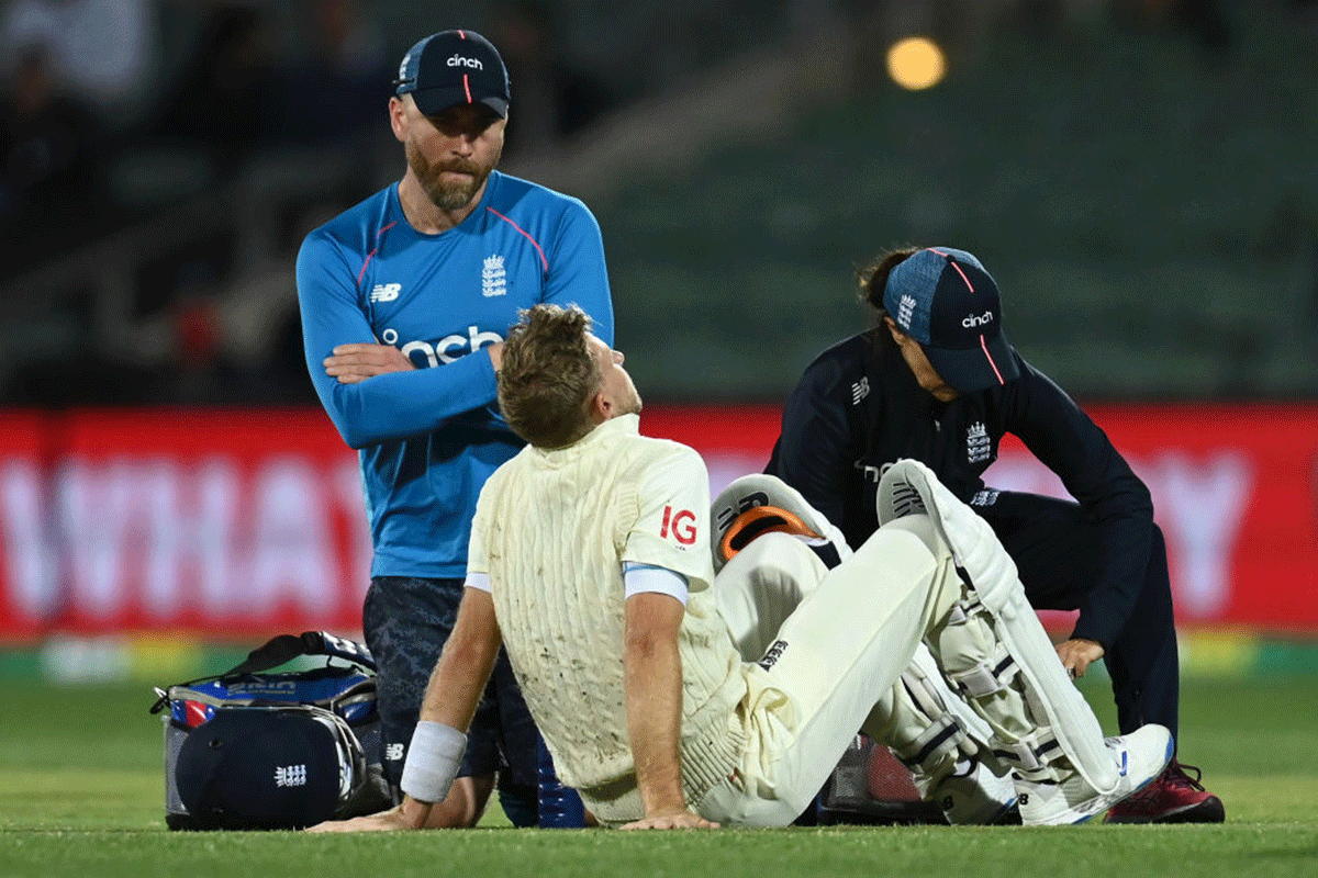 Joe Root seeks medical attention after being hit in the groin by a Mitchell Starc delivery