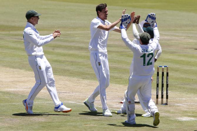 Marco Jansen celebrates with teammates after dismissing Virat Kohli