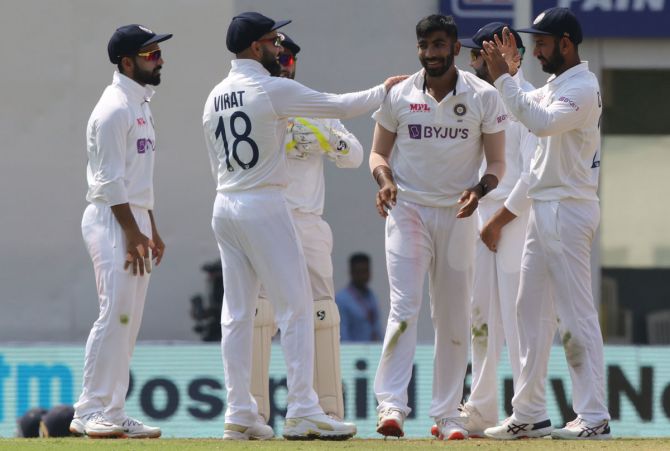 Pacer Jasprit Bumrah is congratulated by his India teammates after dismissing England's Dan Lawrence.