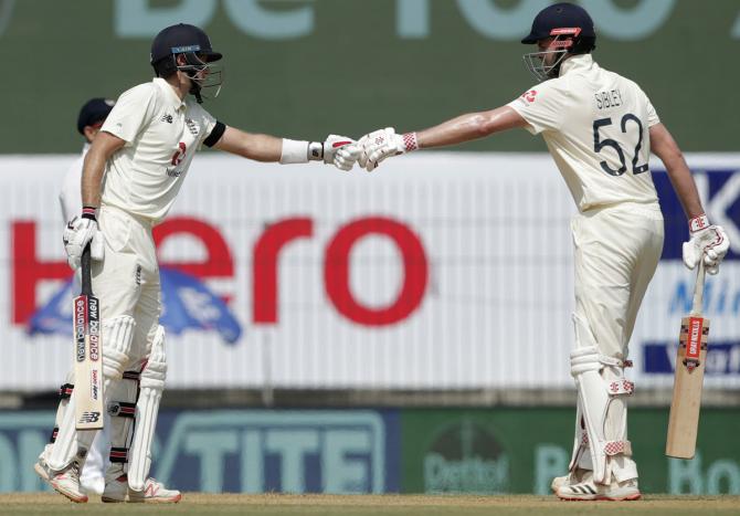 England's Dominic Sibley and Joe Root celebrate their 50-run partnership