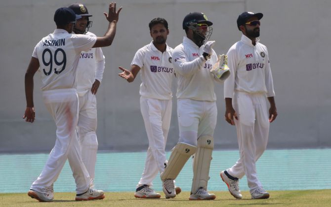 Shahbaz Nadeem is congratulated by his India teammates after dismissing Ben Stokes