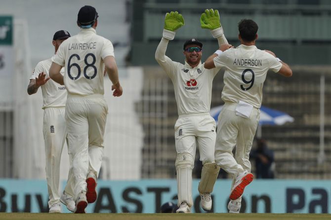 England's players celebrate the wicket of Ajinkya Rahane
