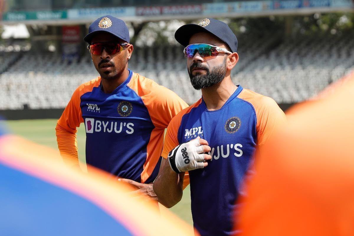 Virat Kohli speaks to players in the nets on Friday