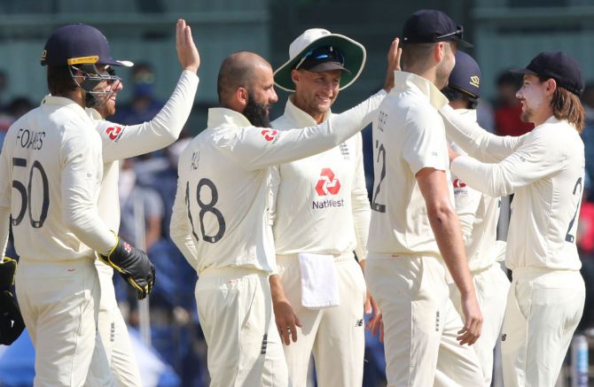 England's players celebrate the wicket of Ishant Sharma