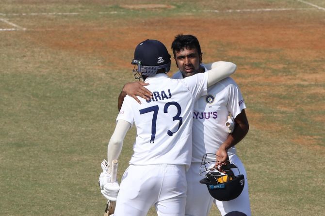 Ravichandran Ashwin is congratulated by Mohammed Siraj after completing a hundred.