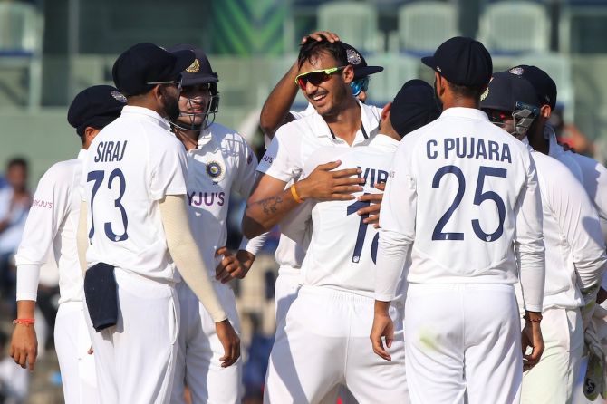Axar Patel is congratulated by his India teammates after dismissing Dom Sibley