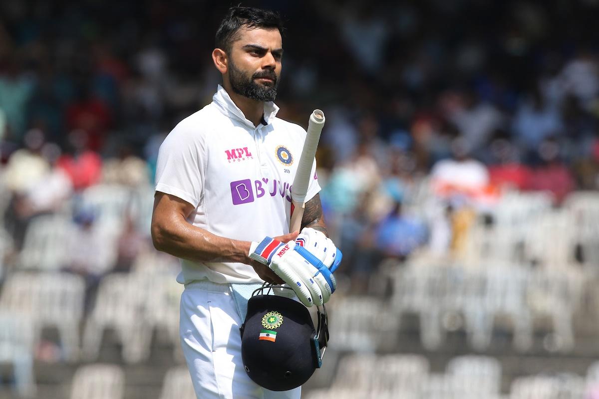 Virat Kohli walks back after being dismissed leg before by Moeen Ali