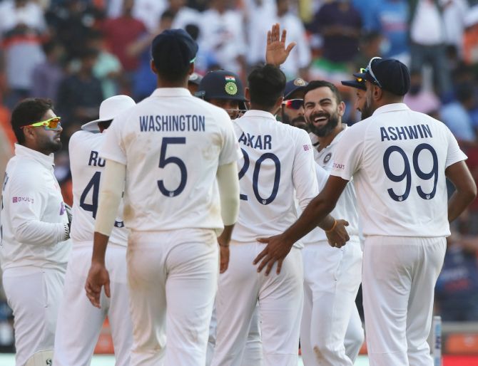 India's players celebrate the wicket of Stuart Broad