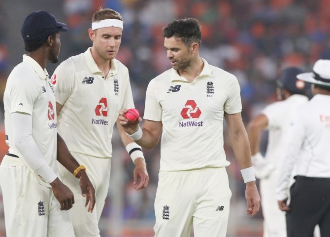 England's pace trio of Jofra Archer, Stuart Broad and James Anderson examine the ball at the start of  India's first innings 