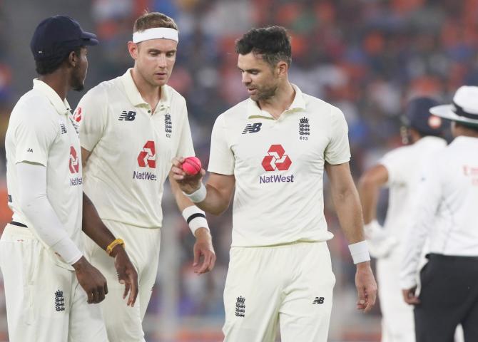 England's pace trio of Jofra Archer, Stuart Broad and James Anderson examine the ball at the start of  India's first innings 