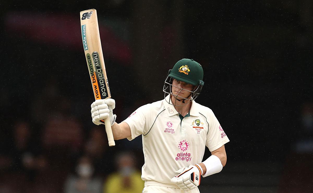 Steve Smith celebrates after completing his half century