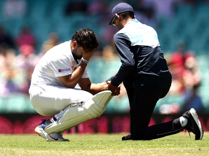Rishabh Pant receives treatment after being struck by a delivery from Pat Cummins during Day 3 of the third Test between Australia and India, at the Sydney Cricket Ground, on Saturday.