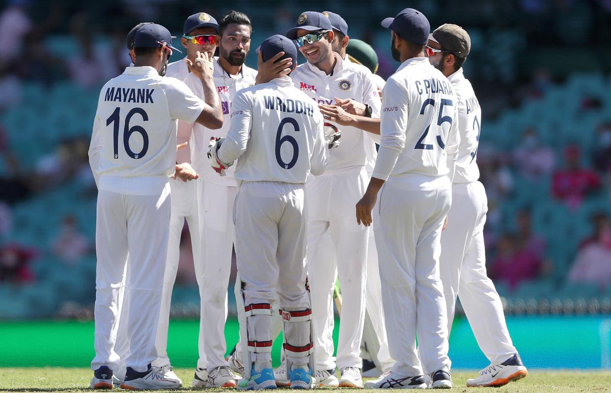 India's players celebrate the fall of an Australian wicket during the third Test in Sydney