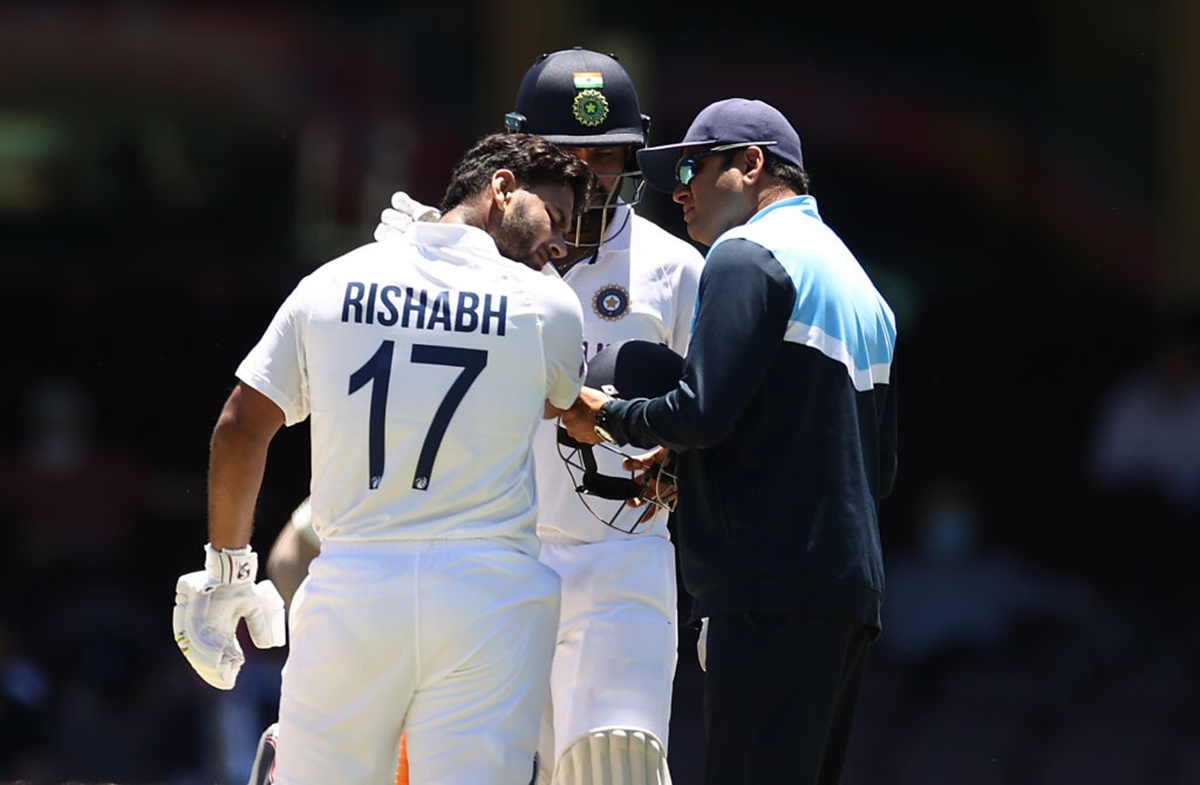 Rishabh Pant is assessed after being stuck on the helmet.