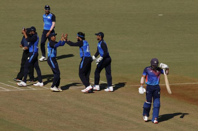 Saurashtra players celebrate the wicket of a Vidarbha player during their Syed Mushtaq Ali Trophy match in Indore on Wednesday