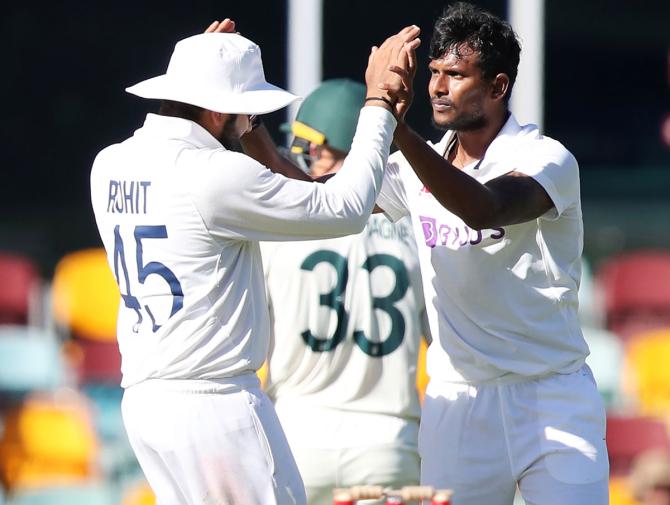 India debutant Thangarasu Natarajan is congratulated by Rohit Sharma after dismissing Australia's Marnus Labuschagne