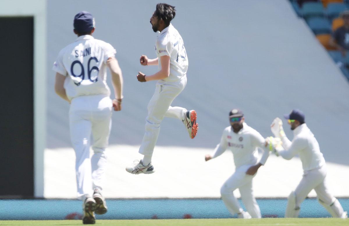 India pacer Mohammed Siraj celebrates dismissing Australia opener David Warner during Day 1 of the fourth Test, at the Gabba, on Friday. 