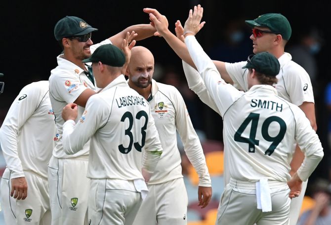 Australia's players celebrate after Nathan Lyon dismisses Rohit Sharma