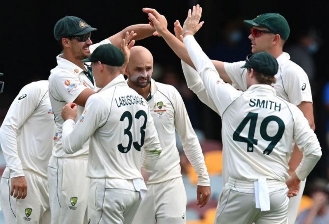 Australia's players celebrate after Nathan Lyon dismisses Rohit Sharma.