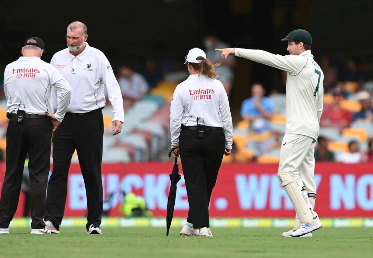 Australia captain Tim Paine speaks to the umpires during the rain delay on Day 2 of the 4th Test at The Gabba on Saturday