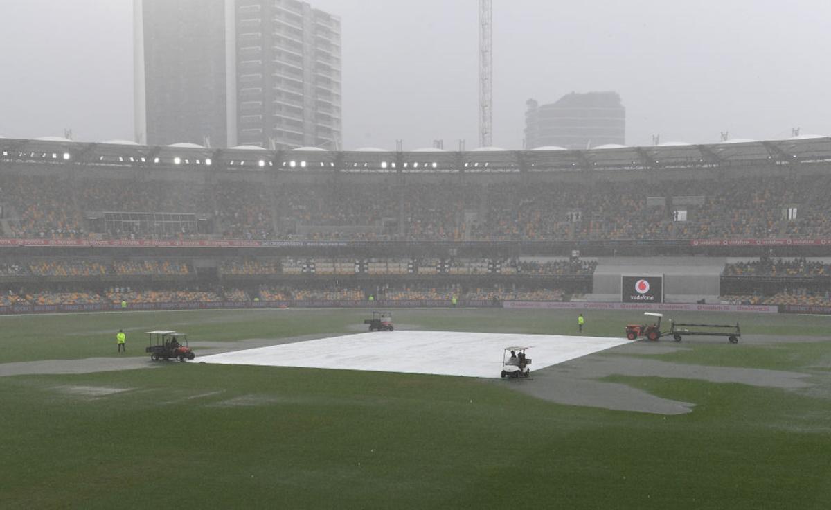 Groundsmen cover the pitch as rain stops play after tea on Day 3