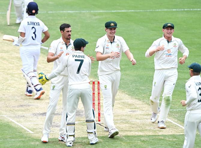 Mitchell Starc celebrates with Tim Paine after dismissing Ajinkya Rahane.