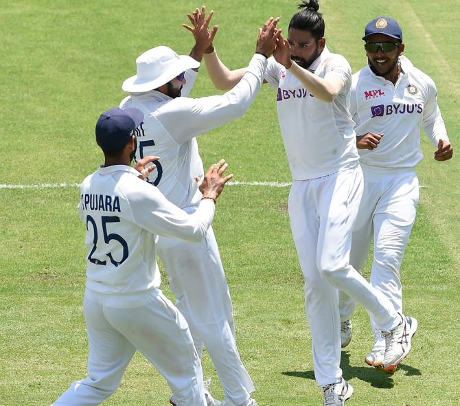 Mohammed Siraj celebrates after dismissing Matthew Wade.