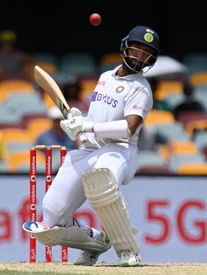 Cheteshwar Pujara ducks to avoid a bouncer.