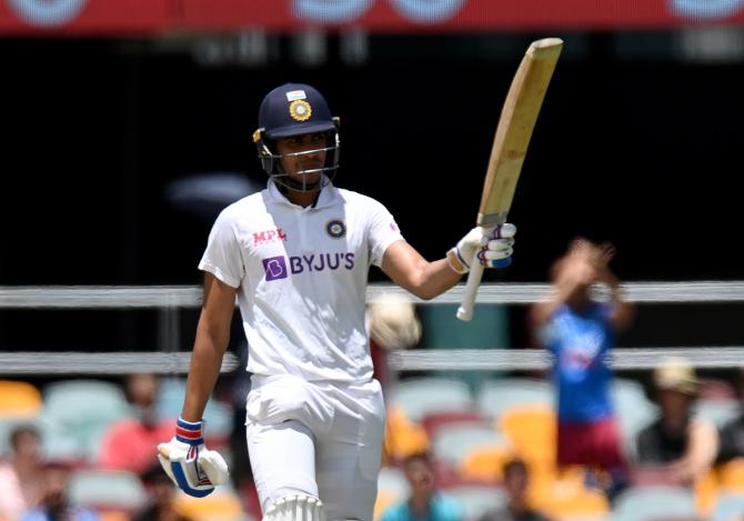 Opener Shubman Gill waves to the dressing room after completing a half-century in India's second innings on Day 5