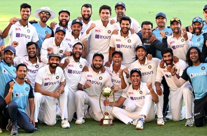 The Indian team celebrates with the Border-Gavaskar Trophy after victory over Australia on Day 5 of the fourth Test, at the Gabba, in Brisbane, on Tuesday.
