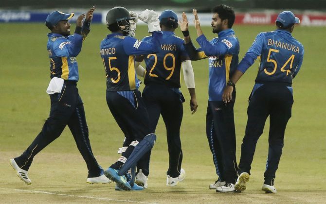 Sri Lanka's Dhananjaya de Silva celebrates with teammates after taking the wicket of India's Prithvi Shaw