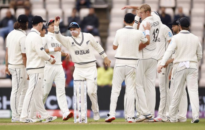 New Zealand's pacer Tom Latham celebrates with teammates after catching Rishabh Pant off the bowling of Kyle Jamieson.
