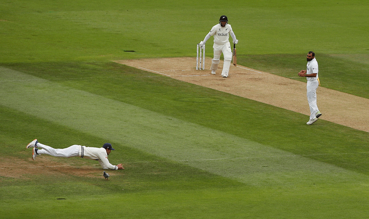 India's Shubman Gill takes a catch to dismiss New Zealand's Ross Taylor off the bowling of India's Mohammad Shami 