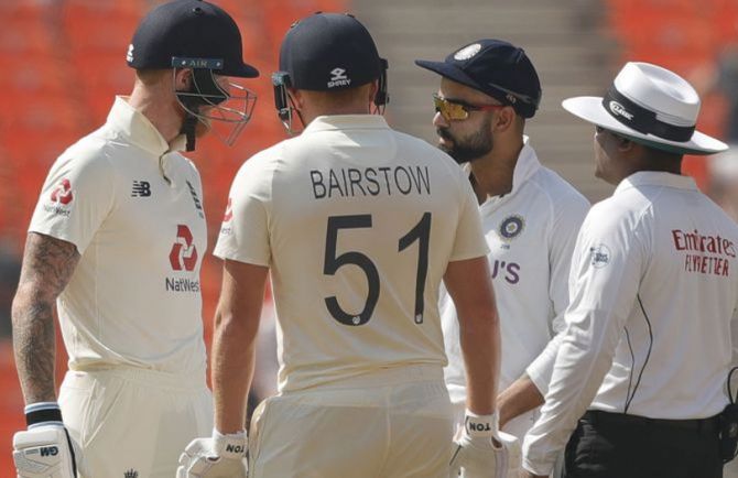 India captain Virat Kohli and England's Ben Stokes exchange words while umpire Nitin Menon intervenes