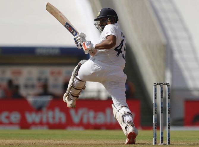 Rohit Sharma goes on one foot to send the ball to the fence