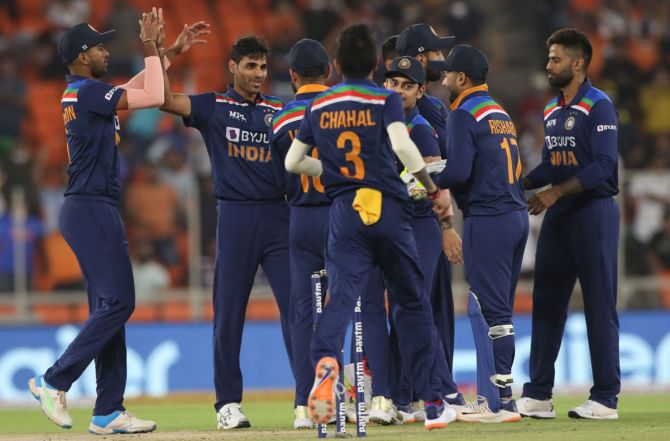India's players celebrate after Bhuvneshwar Kumar dismisses England's Jos Buttler in the second T20 in Ahmedabad on Sunday