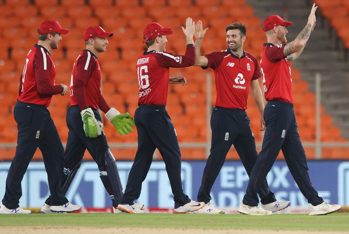 Mark Wood celebrates after dismissing Rohit Sharma