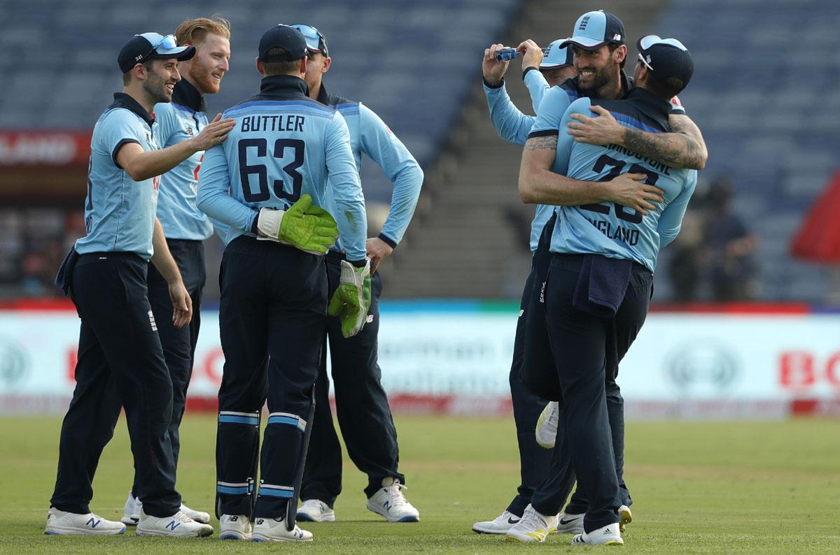 England's players celebrate Hardik Pandya's dismissal.