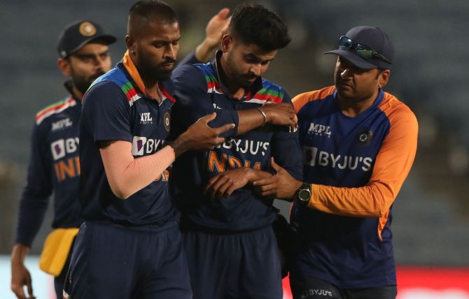 Shreyas Iyer, centre, is helped off the field after injuring his shoulder