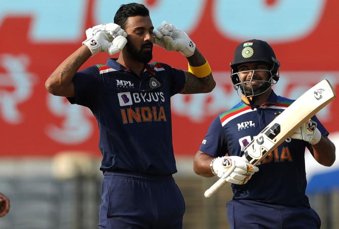 K L Rahul celebrates scoring a hundred, as Virat Kohli applauds during the second ODI against England on March 26, 2021, in Pune.  