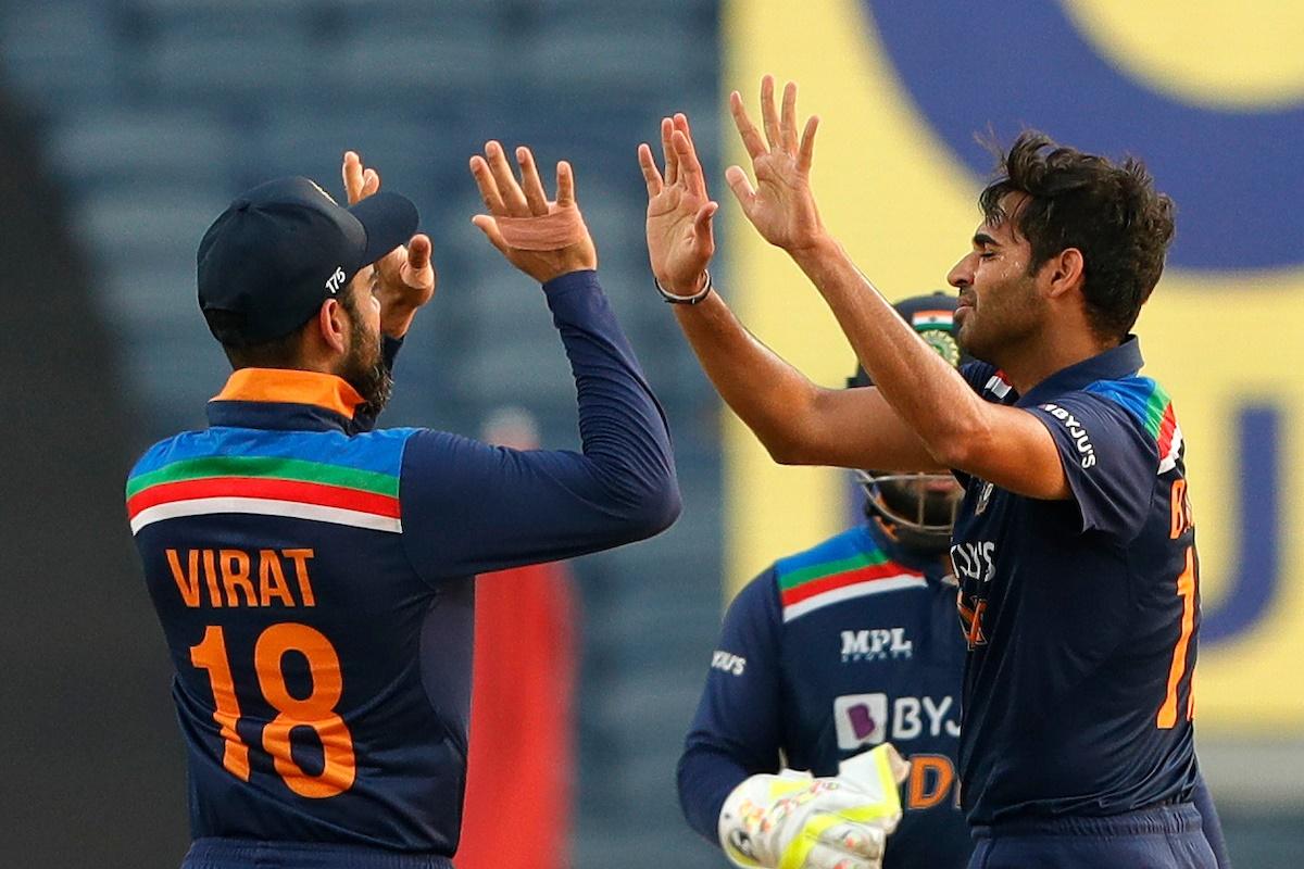 Bhuvneshwar Kumar celebrates with Virat Kohli after dismissing Jonny Bairstow.