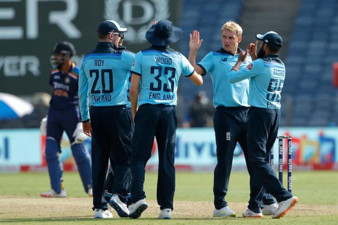 England's players celebrate after Sam Curran dismisses Rishabh Pant during the third ODI against India, in Pune, on Sunday.