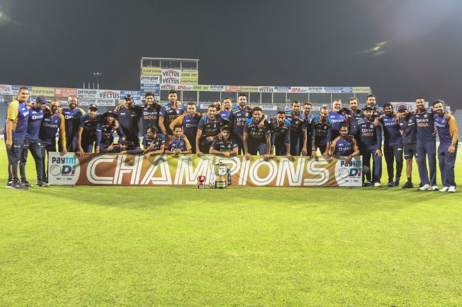 India’s players pose for the camera after defeating England in the third ODI and winning the series 2-1, in Pune, on Sunday