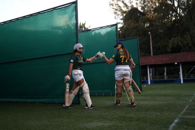 Members of Brazilian cricket team greet each other during a practice session in Pocos de Caldas, Minas Gerais state.  The sport has grown considerably over the last few years – especially among females – and Brazil's women's teams have won four of the last five South American championships.