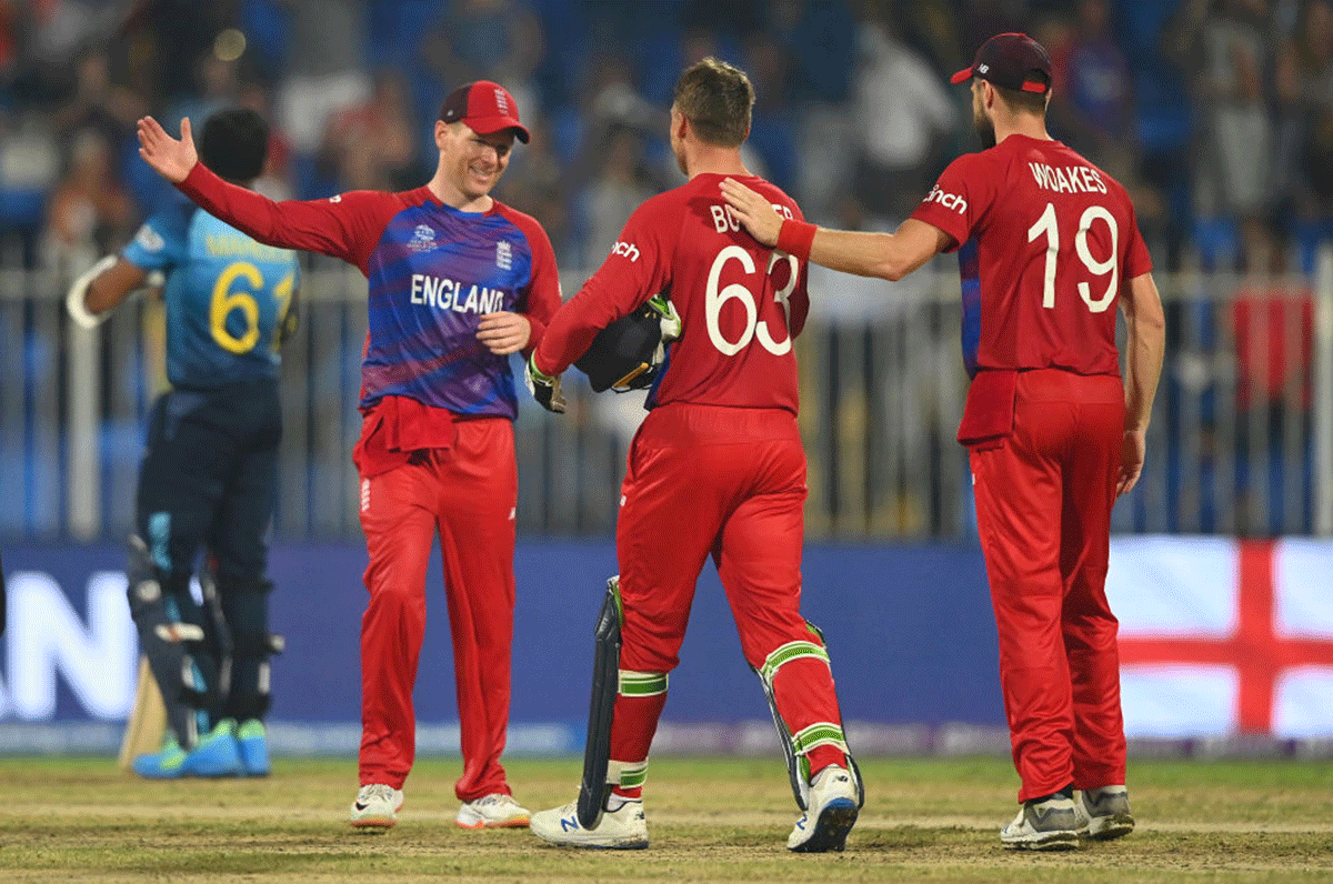 Eoin Morgan, Jos Buttler and Chris Woakes celebrate their win over Sri Lanka in Sharjah on Monday 