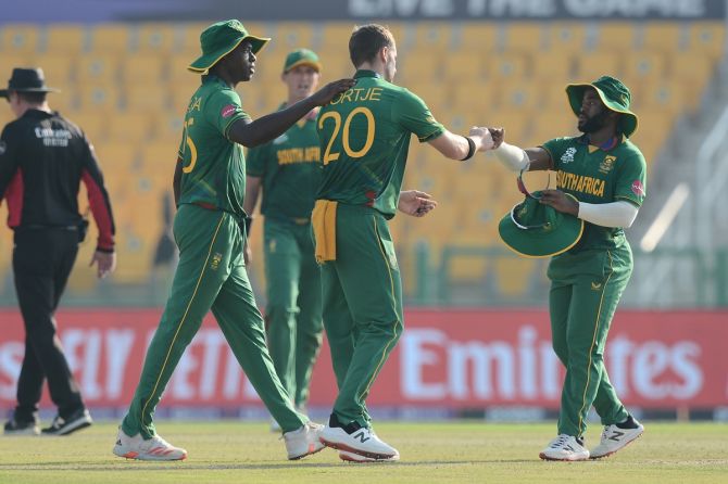 South Africa captain Temba Bavuma, right, congratulates pacers Anrich Nortje, centre, and Kagiso Rabada on their brilliant bowling in the T20 World Cup Super 12s match against Bangladesh, at Sheikh Zayed Stadium in Abu Dhabi, on Tuesday. 