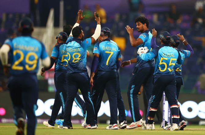 Sri Lanka's players celebrate after Binura Fernando dismisses West Indies opener Chris Gayle early.
