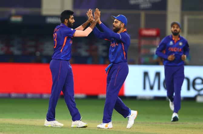 India pacer Jasprit Bumrah gets a high-five from skipper Virat Kohli after dismissing Scotland's opener Kyle Coetzer.